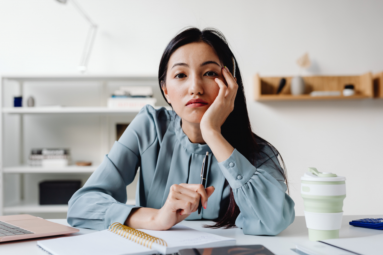 Young Asian Woman At Office Looking Forlorn